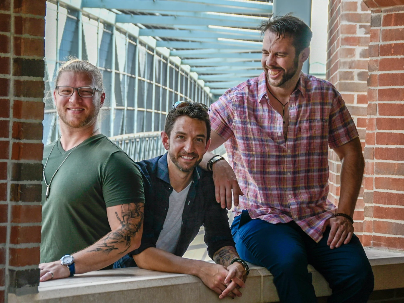 The three members of Cypress Fyre together on a sunlit walkway